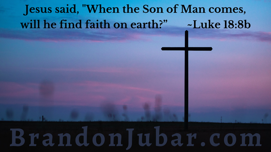 Image of a cross with a purplish sunset behind